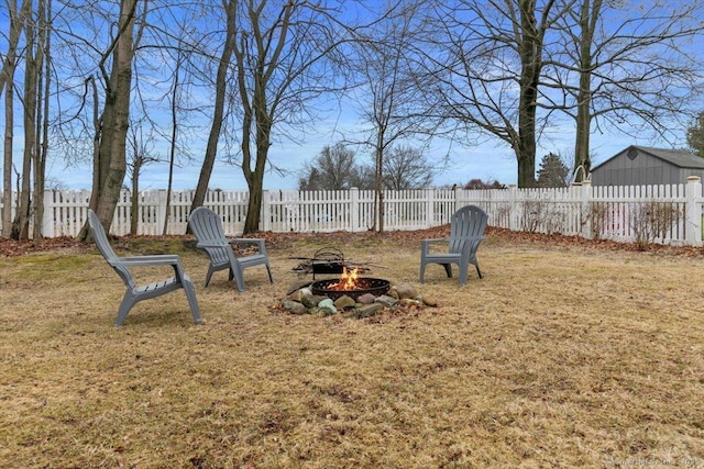 view of yard with an outdoor fire pit and fence private yard