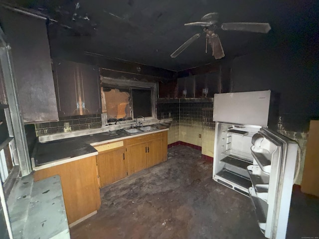 kitchen featuring decorative backsplash, unfinished concrete flooring, and a sink