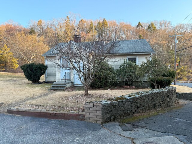 view of property exterior featuring a chimney