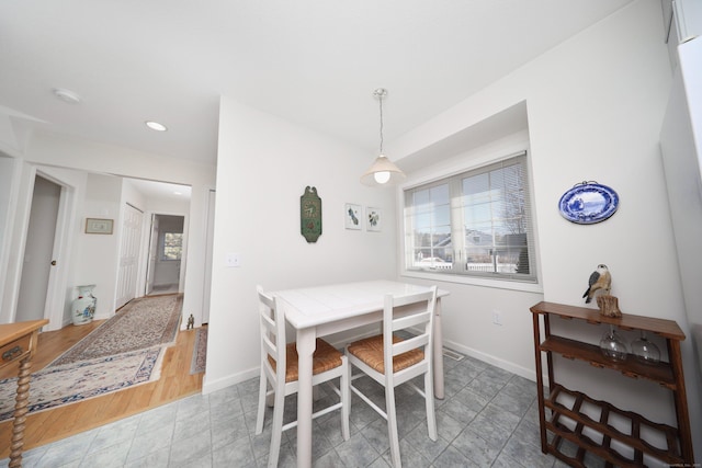 dining space with recessed lighting and baseboards