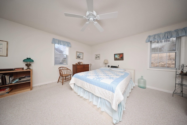 bedroom with a ceiling fan, carpet, and baseboards