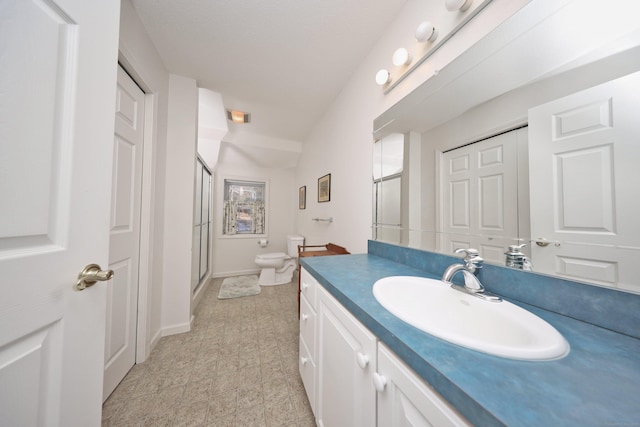 full bathroom with a shower stall, toilet, vanity, and baseboards