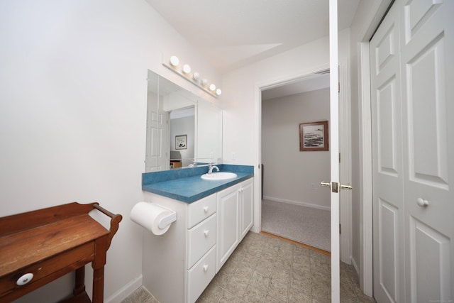 bathroom with tile patterned floors, vanity, and baseboards