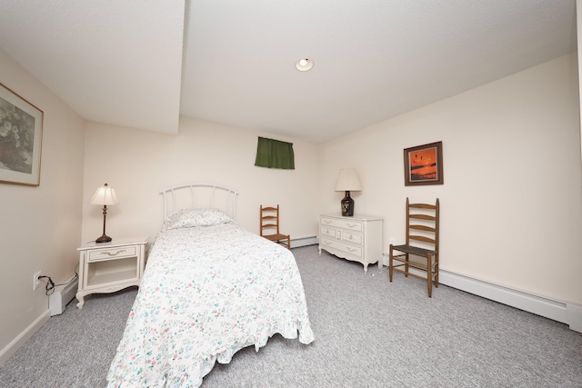 carpeted bedroom with a baseboard heating unit and baseboards