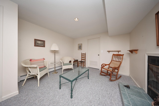 carpeted living area featuring baseboard heating, recessed lighting, a fireplace, and baseboards