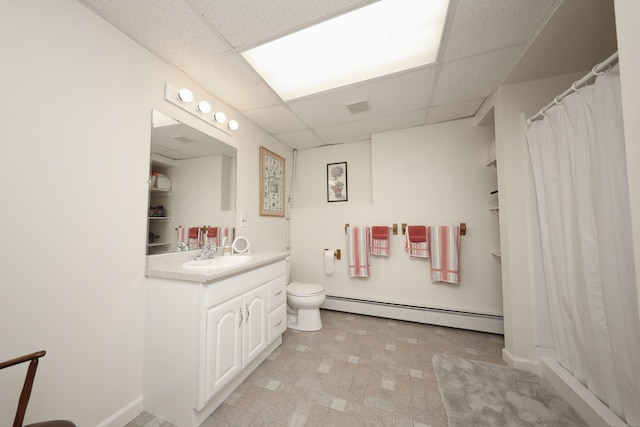 bathroom featuring visible vents, toilet, a baseboard heating unit, a paneled ceiling, and vanity