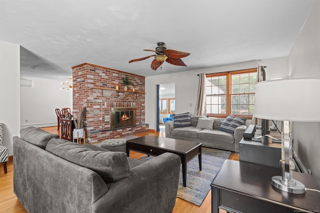 living room featuring a ceiling fan, light wood-style flooring, and a fireplace