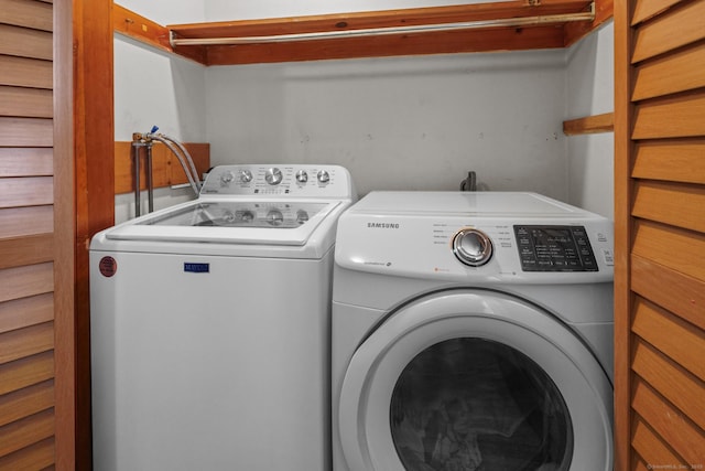 clothes washing area featuring laundry area and separate washer and dryer