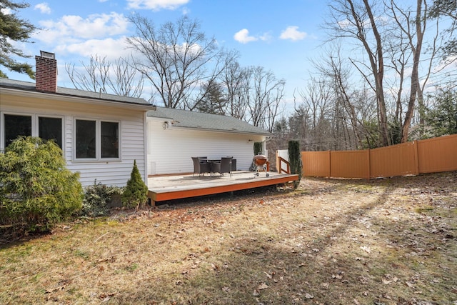 view of yard with a deck and fence