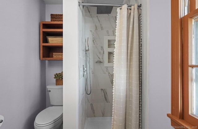 full bathroom with a shower stall and toilet