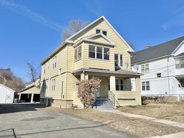 view of front of property featuring a porch and a garage