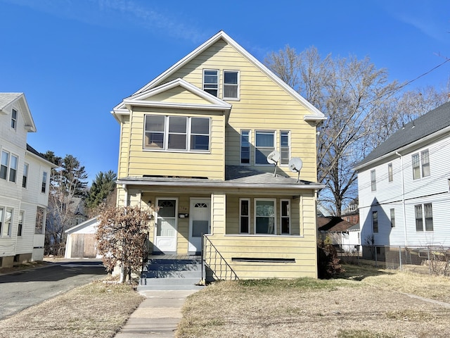 view of front of home featuring covered porch and fence