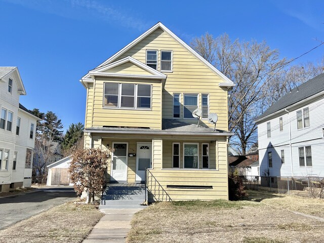 view of front of house with fence and covered porch