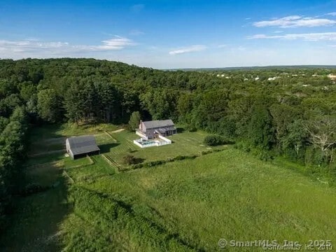 birds eye view of property with a forest view