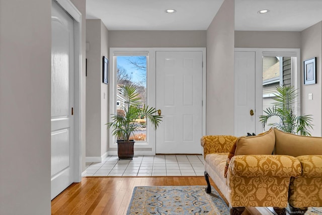 entryway featuring wood-type flooring, baseboards, and recessed lighting