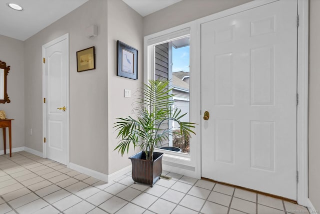 entryway featuring light tile patterned floors and baseboards