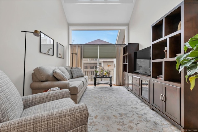 living area with lofted ceiling and light carpet