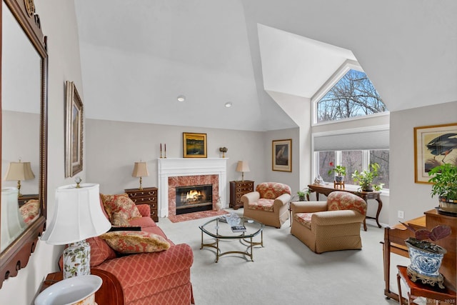 living area with a premium fireplace, high vaulted ceiling, and carpet flooring