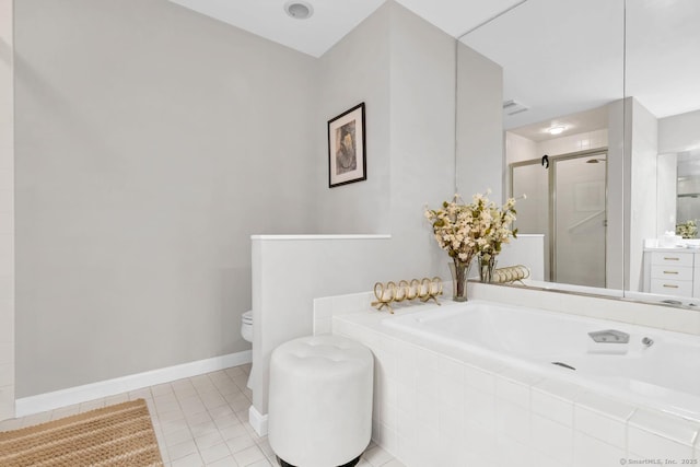 bathroom featuring toilet, vanity, a shower stall, baseboards, and tile patterned floors