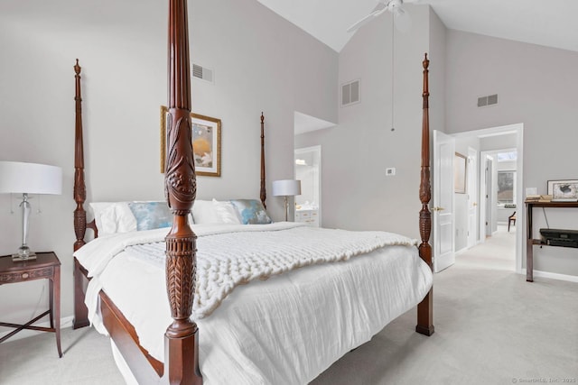 bedroom featuring high vaulted ceiling, light colored carpet, and visible vents