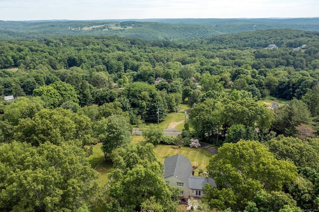 drone / aerial view with a wooded view