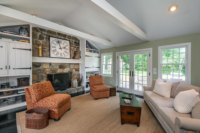 living area featuring a fireplace, lofted ceiling, and french doors