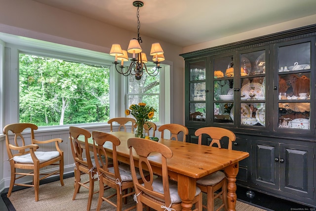 dining area featuring a notable chandelier and lofted ceiling