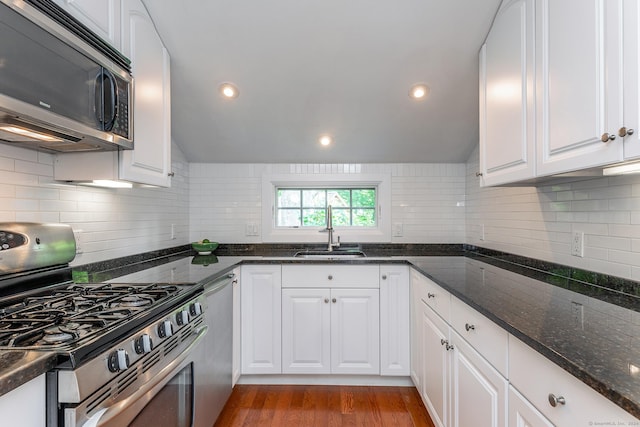 kitchen with a sink, appliances with stainless steel finishes, and white cabinets