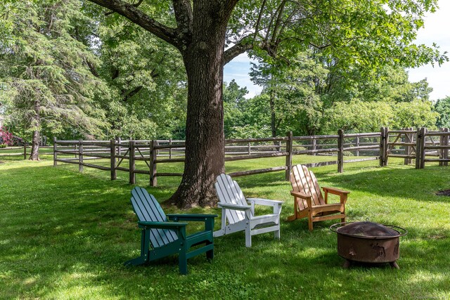 view of yard with a fire pit and fence