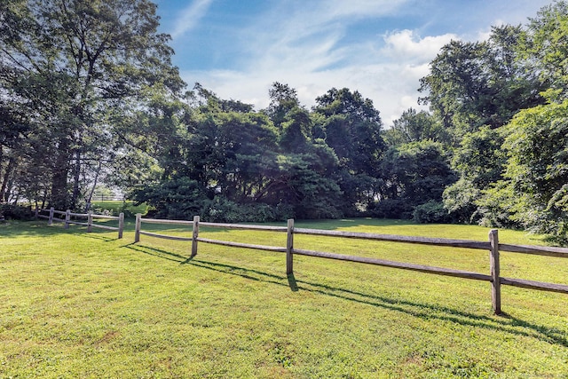 view of yard featuring a rural view and fence