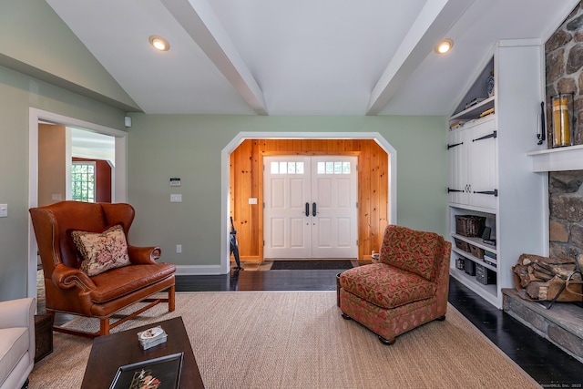 living room featuring vaulted ceiling, built in shelves, wood finished floors, and recessed lighting