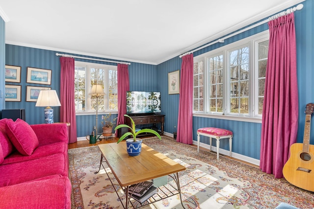 living room with wallpapered walls, crown molding, baseboards, and wood finished floors