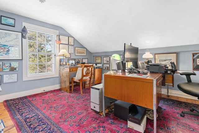 office area featuring wood finished floors, baseboards, and vaulted ceiling