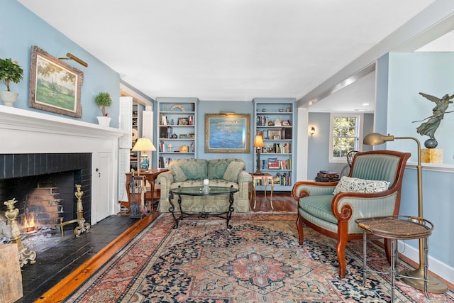 living room featuring a fireplace and wood finished floors