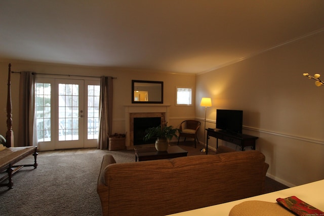 living area with carpet floors, a fireplace, baseboards, and crown molding