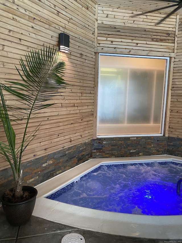 bathroom with wood walls