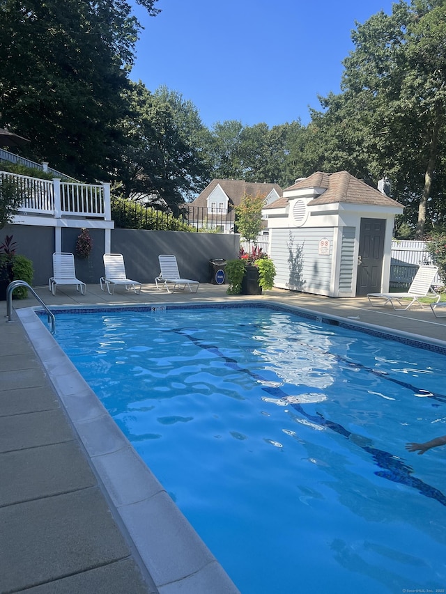 pool with fence and a patio