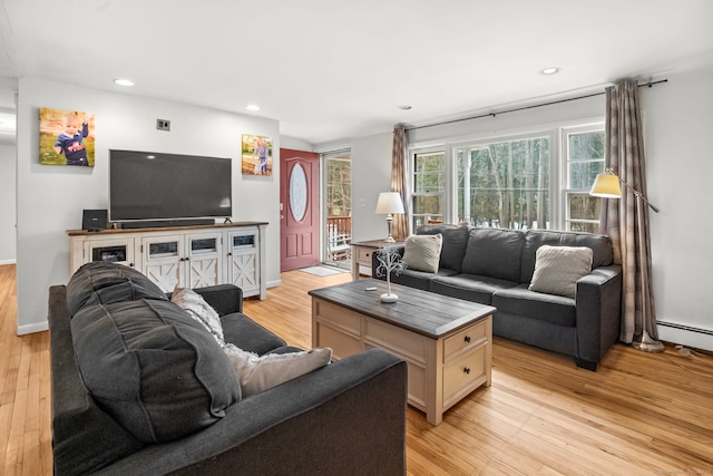 living area featuring light wood-style flooring, recessed lighting, and baseboards