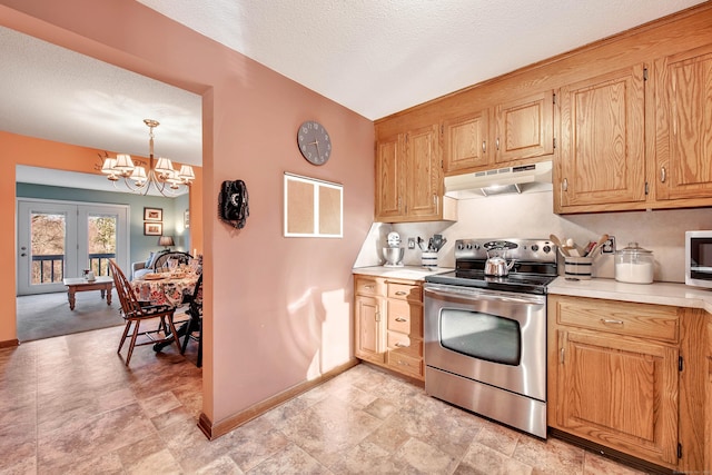 kitchen featuring under cabinet range hood, appliances with stainless steel finishes, light countertops, and a chandelier