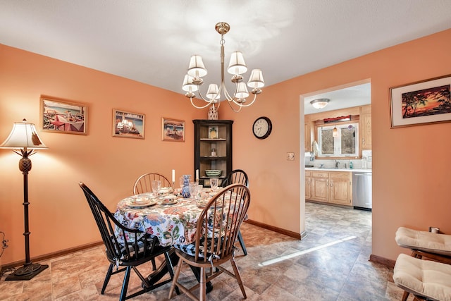 dining room featuring baseboards and a chandelier