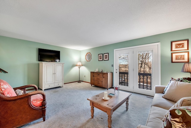 living room with carpet, baseboards, and a textured ceiling