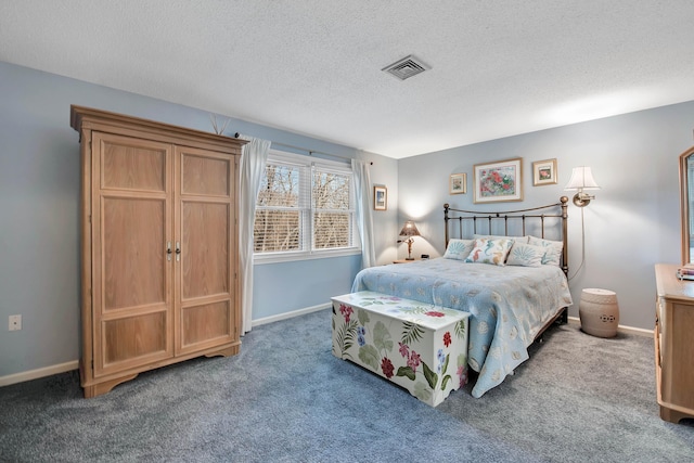 bedroom with a textured ceiling, carpet floors, visible vents, and baseboards