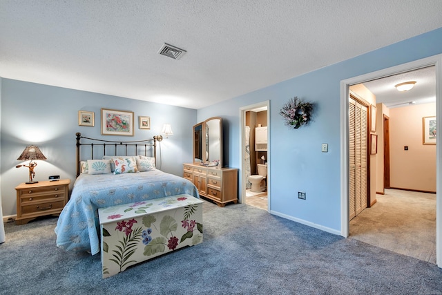 carpeted bedroom with a textured ceiling, ensuite bath, visible vents, and baseboards