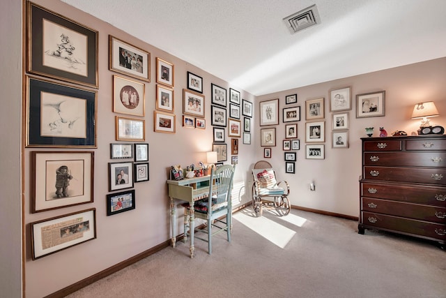 office with visible vents, light carpet, baseboards, and a textured ceiling