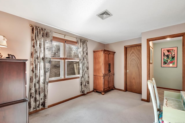 unfurnished bedroom with light colored carpet, visible vents, and baseboards