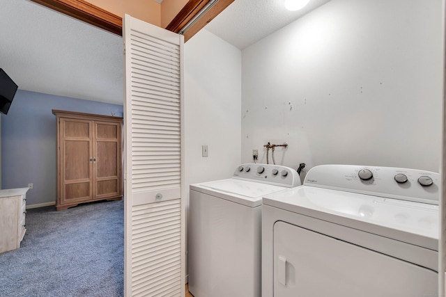 laundry area featuring laundry area, washer and clothes dryer, and light colored carpet