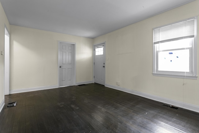 entrance foyer with wood-type flooring, visible vents, and baseboards