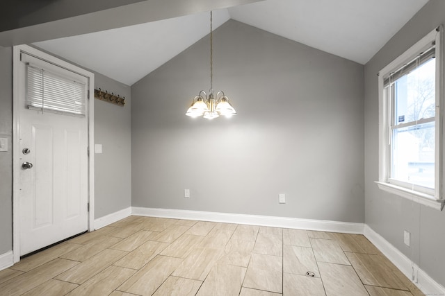 interior space featuring a wealth of natural light, lofted ceiling, baseboards, and an inviting chandelier