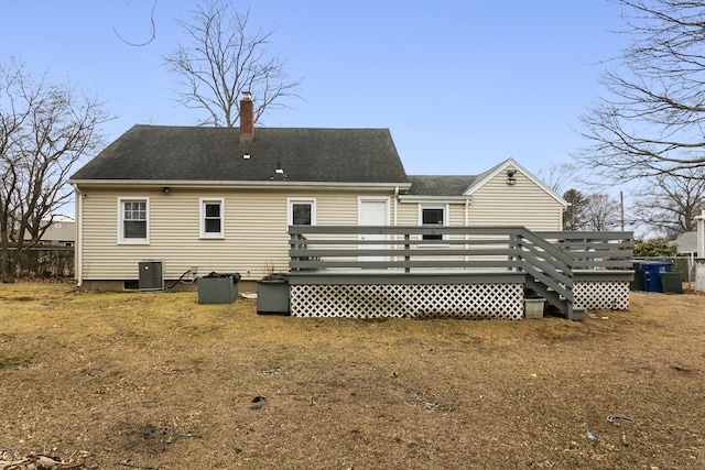 back of property featuring a shingled roof, a chimney, central AC, and a deck