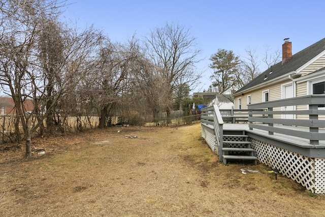 view of yard with fence and a deck